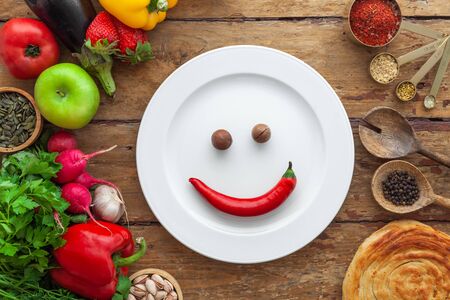 Frame of products, vegetables, herbs, oriental spices, white plate with space for textの写真素材