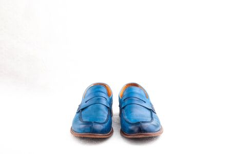 Pair of old leather blue discarded boots with lacesの写真素材