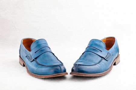 Pair of old leather blue discarded boots with lacesの写真素材