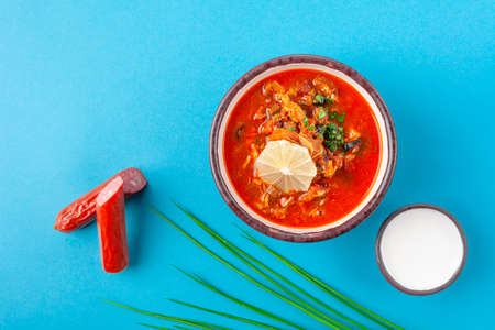 Traditional Russian dish solyanka, red soup with different meatの写真素材