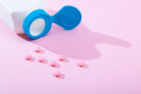 Tablets and pills, vitamins and antibiotic on pink background, copy spaceの写真素材