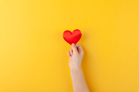 Girl holds in hands red hearts, children arms, love and valentines day conceptの写真素材