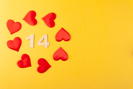 Red hearts, golden numbers 14 on yellow background, greeting card february valentines day
