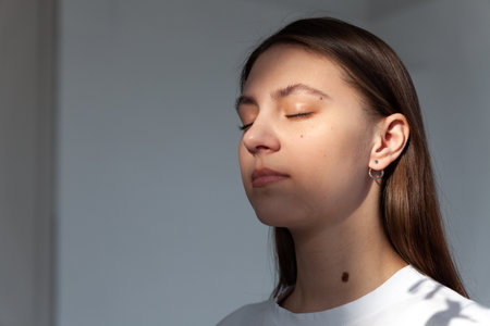 Beautiful jewelry model in modern silver round minimal earringsの写真素材