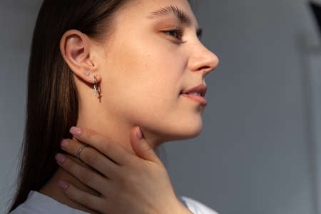 Beautiful jewelry model in modern silver round minimal earringsの写真素材