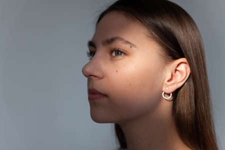 Beautiful jewelry model in modern silver round minimal earringsの写真素材