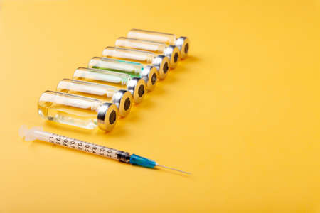 Glass vaccine ampoules, bottles, syringes, medicines, top viewの写真素材