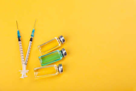 Glass vaccine ampoules, bottles, syringes, medicines, top viewの写真素材