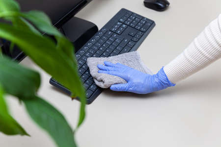 Disinfecting computer, antibacterial spray, rag, safe working from homeの写真素材