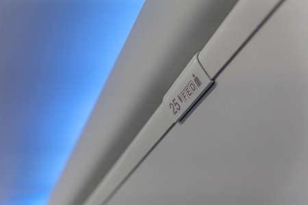 Sign of seat number with number and letter on luggage shell inside passenger airplaneの写真素材