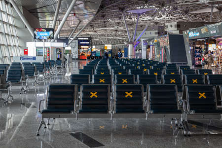 Empty airport, social distancing stickers on seats, Russia Moscow Vnukovo 2021-02-28のeditorial素材