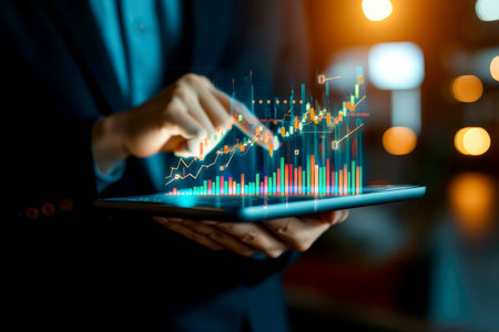 businessman points at a chart depicting financial goals and worldwide business planning.の素材