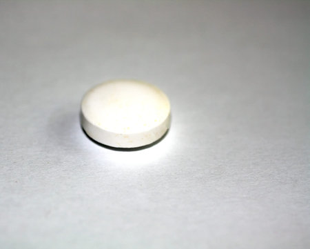 A large white tablet. Aspirin, medicine medicament.