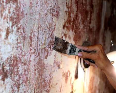 Preparing walls for wallpaper with a spatula. Repair in the apartment.の写真素材