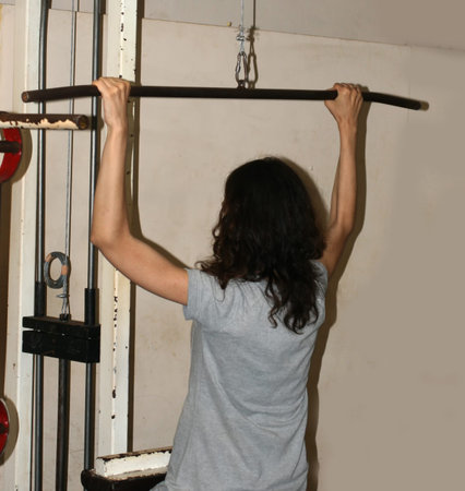 Workout fitness exercises in the gym. Power simulator for hands. Gymnastics.