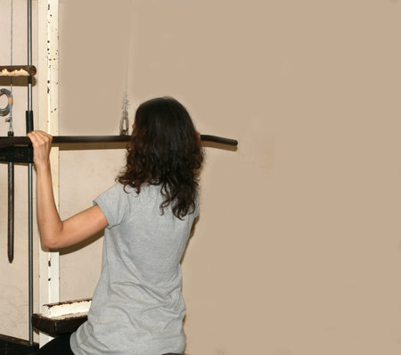 Workout fitness exercises in the gym. Power simulator for hands. Gymnastics.