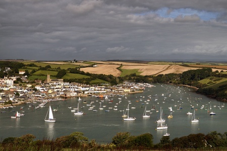 Sailing boats in Devon bay with fields in the background. Salcombe town on the left side.の写真素材