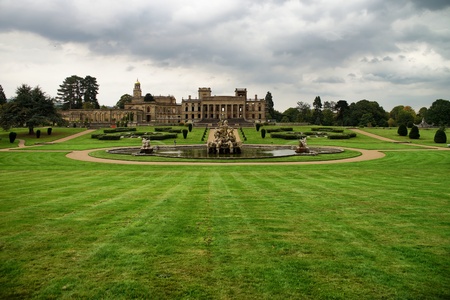 Witley Court garden with fountain. Dramatic sky. Green grass.のeditorial素材