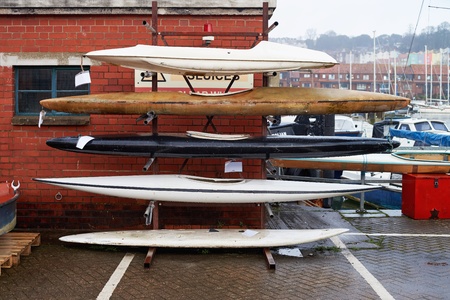 Kayak rental. Old kayaks on the rack.の写真素材