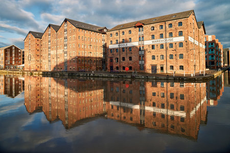 Gloucester docks warehouses reflected in the canal.