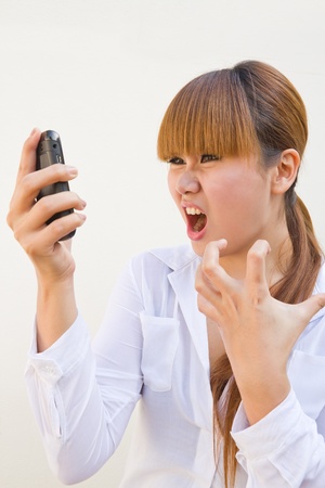brunette woman screaming at phoneの写真素材