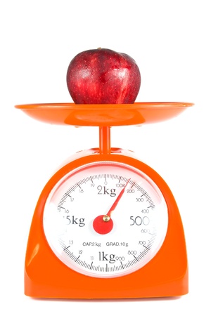 one apple lying on weight scaleの写真素材