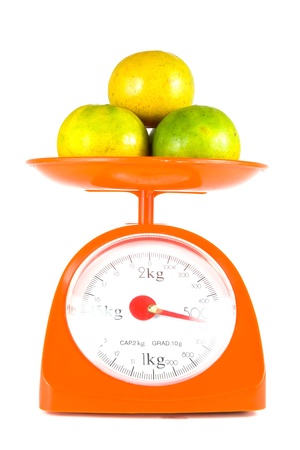 many orange lying on weight scaleの写真素材
