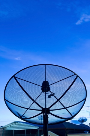 Black satellite dish in community on nighttime sky backgroundの写真素材