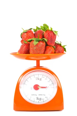 many fresh strawberry lying on weight scaleの写真素材