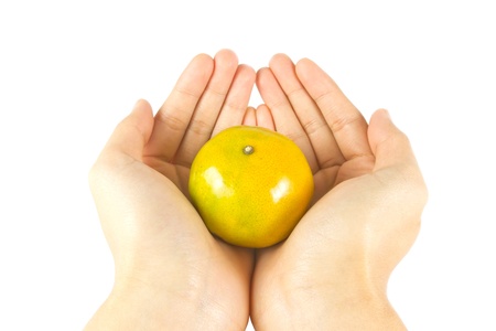 give fresh orange with handの写真素材