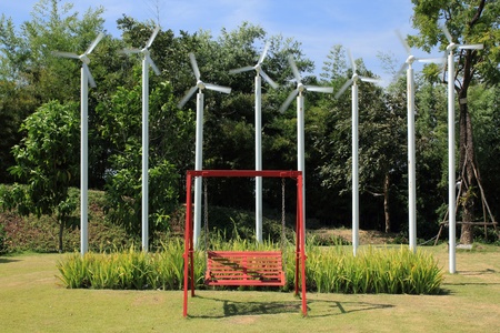 swing in garden and wind wheel backgroundの写真素材