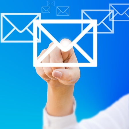 finger choosing mail symbol on blue backgroundの写真素材