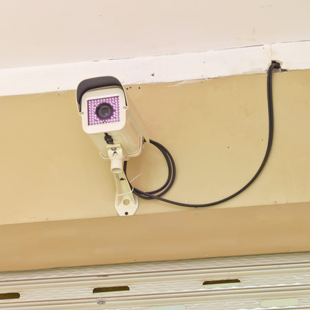 cctv camera on wall in nighttime