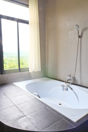bathroom in luxury home with nature outside windowの写真素材