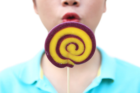 women holding round swirl lollipop colorful on white backgroundの写真素材