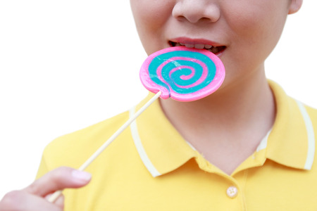 women holding round swirl lollipop colorful on white backgroundの写真素材