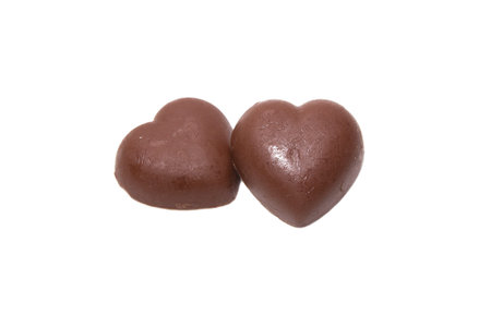 Two chocolate hearts on white backgroundの写真素材