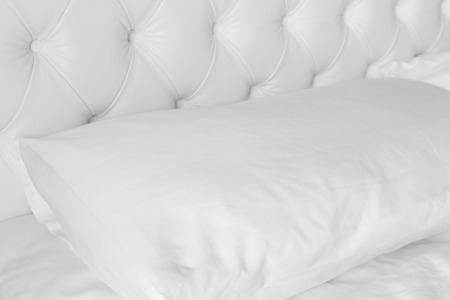 Close up white pillow on white luxury bed.の写真素材