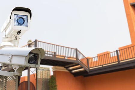 The CCTV Security Camera operating on big wall classic castle blur background.の写真素材