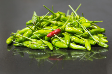 Hot Chilli Peppers on black granite table background.の写真素材