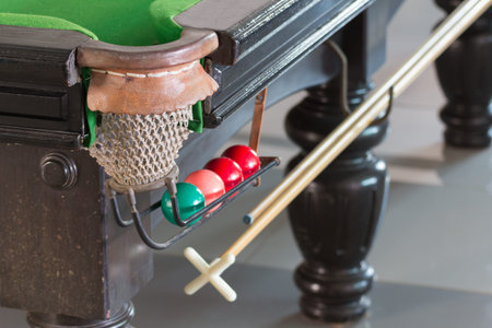 Old snooker table and ball set, in the club background.