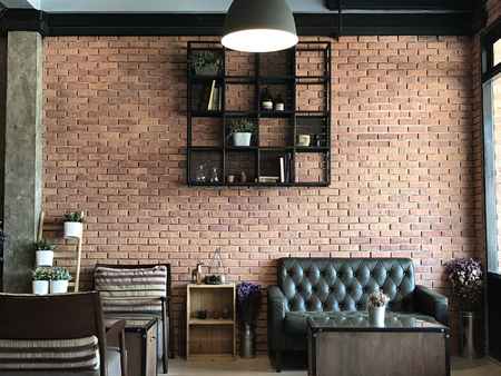 Vintage room with sofa set brick wall background, in the cafe.の写真素材