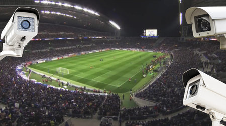 The CCTV Security Camera operating in football stadium at night time background.