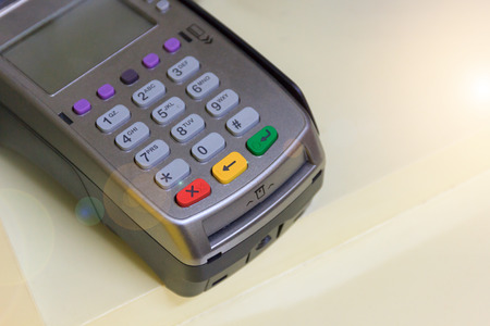 Close up credit card machine on wood table.の写真素材