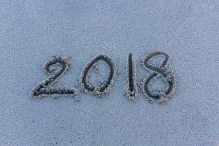 Number 2018 years on sand at the beach. Text lettering design card template. Creative typography for Holiday Greeting Gift Poster. Calligraphy font style Banner.の写真素材