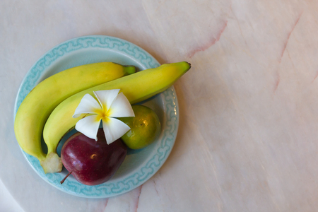 Welcome fruit set, on white stone table in luxury resort.の写真素材