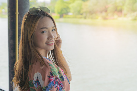 Asian beautiful woman smiling on nature background, vacation holidays portrait concept.の写真素材