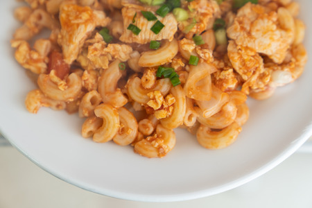 Close up macatoni tomato sauce on white dish, with shroud plastic.の写真素材
