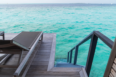 Beautiful tropical Maldives island summer vacation relaxing at overwater villa in luxury resport.の写真素材