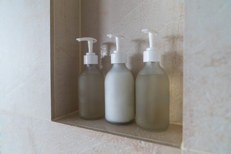 Close up tree bottles pump in bathroom, object interior room background.の写真素材